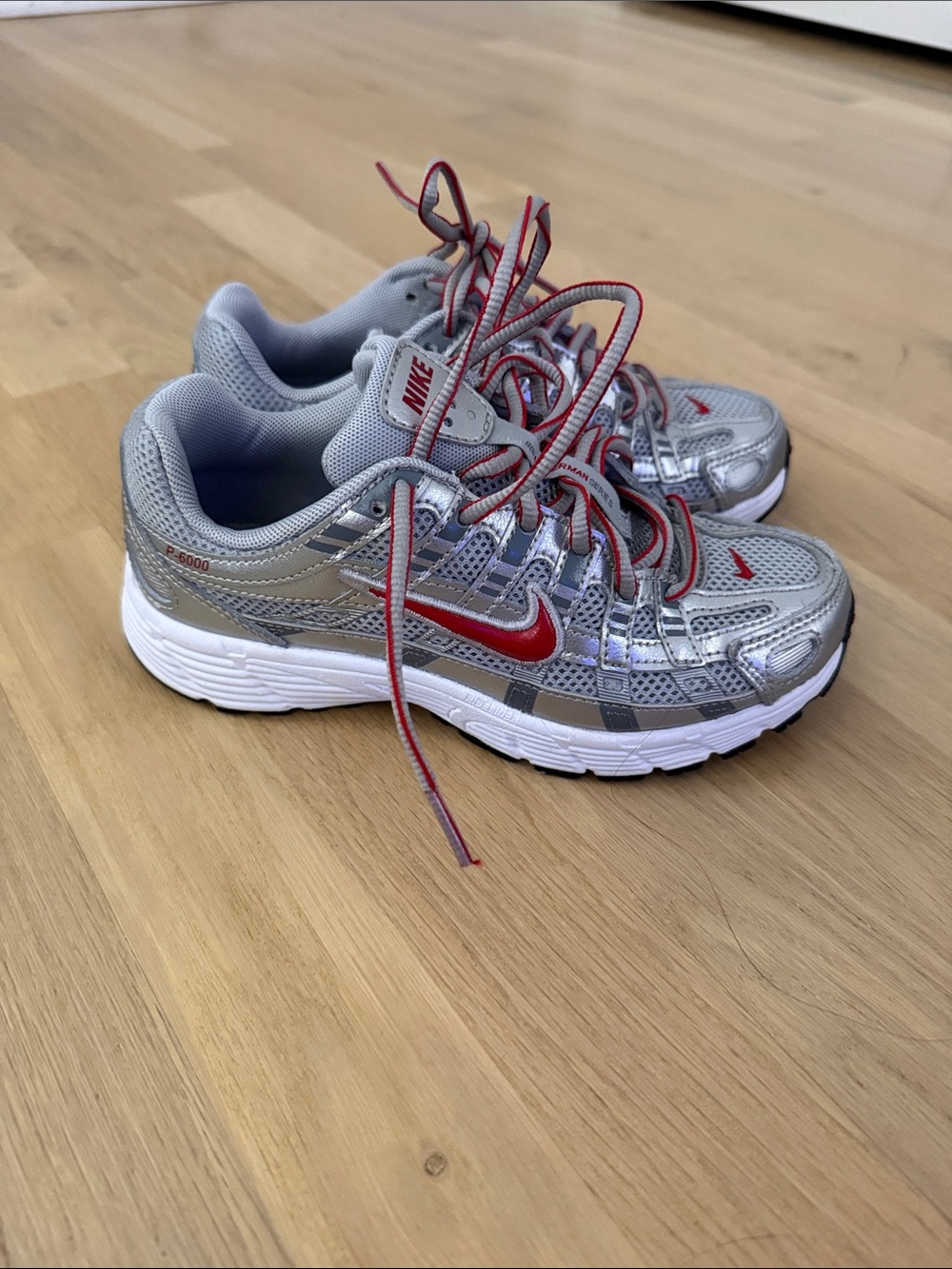 Nike Kids Silver Sneakers with Red Swoosh